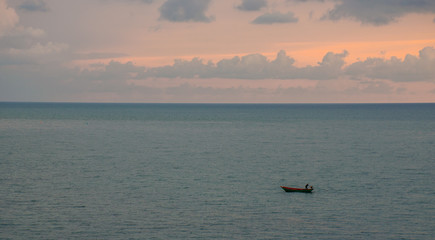 Obraz premium Colorful ocean beach sunrise with deep blue sky and sun rays.