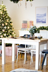 Christmas table in the kitchen with a festive Christmas tree decorated with toys. New Year's cuisine.