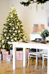 Christmas table in the kitchen with a festive Christmas tree decorated with toys. New Year's cuisine.
