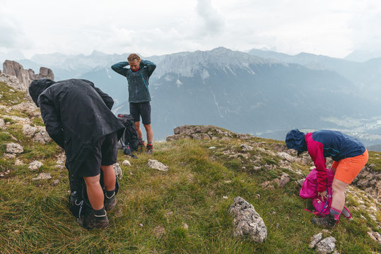 hikers putting on their rain jackets in the dolomites