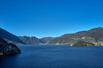 Panoramic top view of Lake Como. Lombardy, Italy. Villa del Balbianello, famous villa in the comune of Lenno. Autumn season. Perfect clear blue sky.