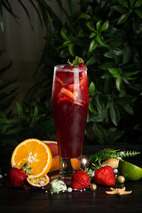 lemonade with cranberries and citruses in a tall glass