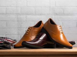 Men fashion office shoes on white brick background.