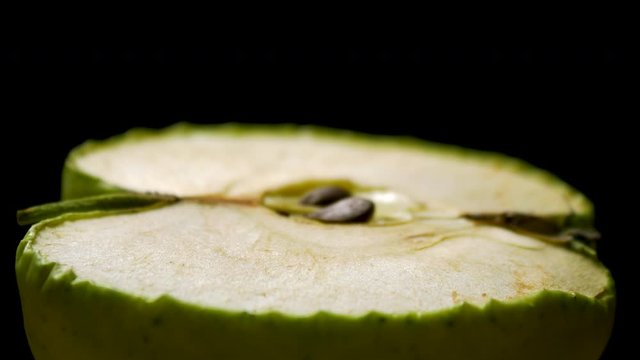 Half of green fresh apple quickly dried out, decay time lapse shot, isolated on white background. Fruit become dry and shrivel, decrease in size with time