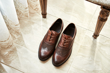 Men's shoes lie on the floor. Different accessories of businessman for creating style of  people on...