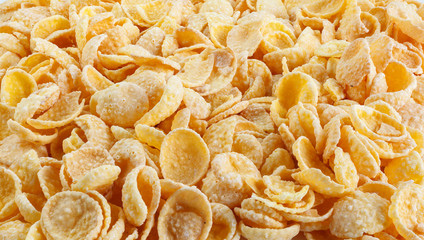 Corn-flakes background and texture. Top view. Traditional dry breakfast cereal. Placer of corn flakes on a white background.