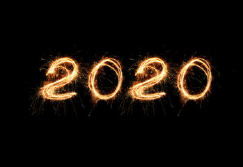 New Year 2020 light. Sparklers draw figures 2020. Bengal lights and letter