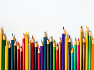 Colored pencils on white wooden background, Stationery Concept. Top view with copy space.