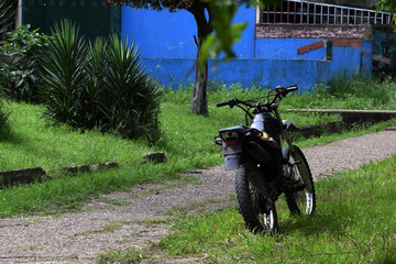 motorcycle stands in the yard on a summer day