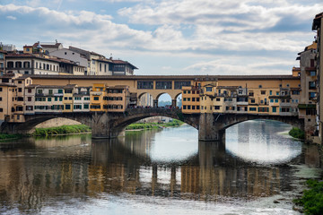 FLORENCE, TUSCANY/ITALY - OCTOBER 20 : Ponte Vecchio across the River Arno in Florence  on October 20, 2019. Unidentified people.