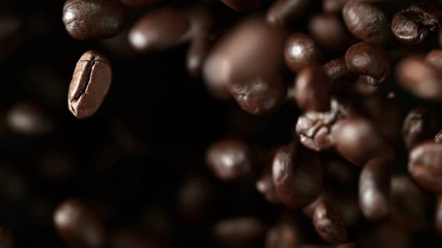 Super slow motion of flying coffee beans in speed ramping. Filmed on high speed cinema camera, 1000 fps.