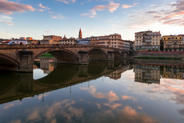 Fototapeta na wymiar FLORENCE, TUSCANY/ITALY - OCTOBER 19 : View of buildings along the River Arno at dusk in Florence on October 19, 2019. Unidentified people