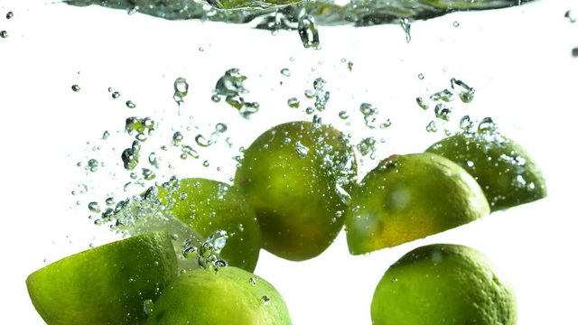 Super slow motion of falling lime isolated on white background with time ramping effect. Filmed on high speed cinema camera, 1000 fps.