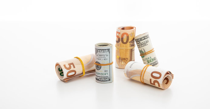 usd and euro banknote rolls isolated against white background.