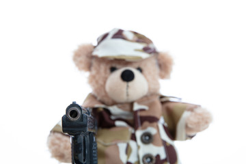 Cute teddy bear in soldier uniform with a handgun isolated against white background