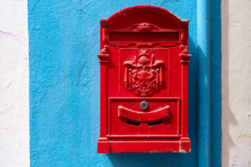 Red mail box.  Red decorative mailbox in the village of Burano in Venetian Lagoon. Colourful post box in Burano, Italy.