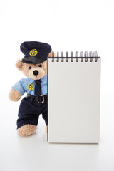 Cute teddy in policeman uniform isolated against white background