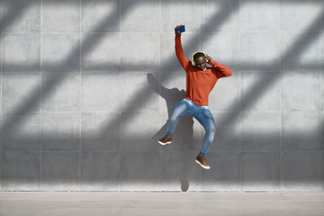 African Man Jumping For Joy Listening To Music