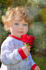 pretty little girl with a rose for mom in the hand
