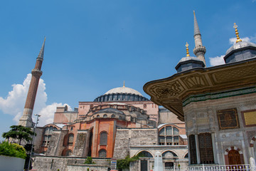 Fototapeta na wymiar Istanbul, Turkey: Ahmet Cesmesi, the Fountain of Sultan Ahmed III built under the Ottoman sultan in 1728, with view of the famous Hagia Sophia, former cathedral then a mosque now a museum