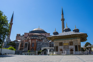 Fototapeta na wymiar Istanbul, Turkey: Ahmet Cesmesi, the Fountain of Sultan Ahmed III built under the Ottoman sultan in 1728, with view of the famous Hagia Sophia, former cathedral then a mosque now a museum