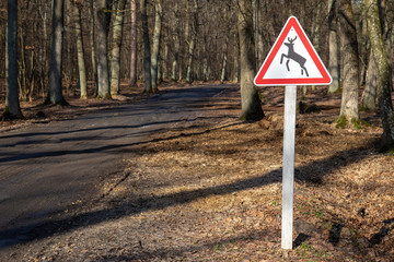 Beware of the deer sign at the road through the woods.