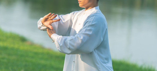 Asian healthy man with Tai Chi pose.