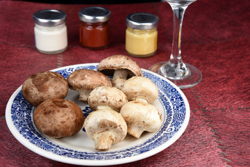 Fresh champignon mushrooms over the table, closeup. Space for text