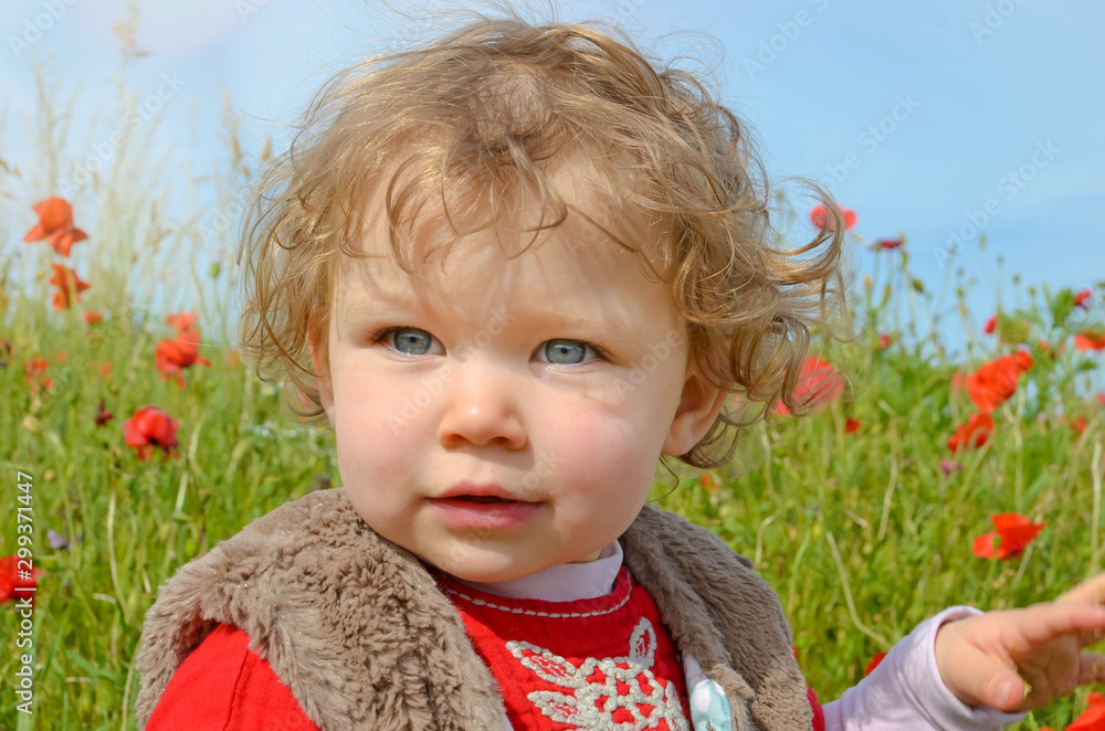 Sticker pretty little girl playing in a field of poppies in bloom