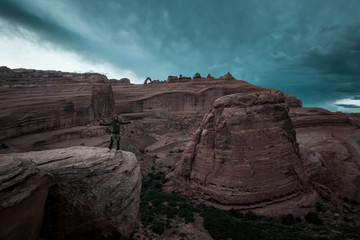 Jesus Christ pose on a edge of a rock in Arches Park