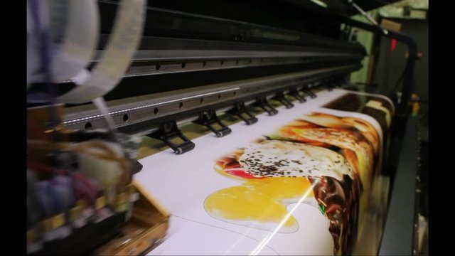 Wide format sing. Peing on the printer.