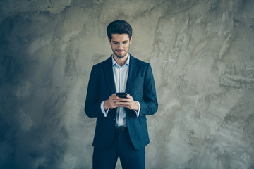 Portrait of stunning classy businessman working on his smartphone text type with partners make new deals wear stylish pants isolated over grey color background