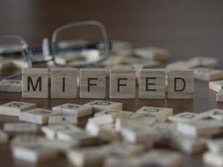 The concept of Miffed represented by wooden letter tiles - obrazy, fototapety, plakaty