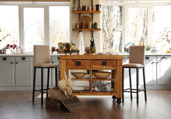 Stylish kitchen interior with wooden table and chairs