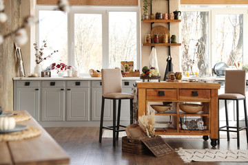 Stylish kitchen interior with wooden table and chairs