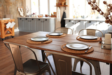 Stylish kitchen interior with dining table and chairs