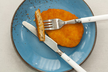 Tasty vegetarian schnitzel on a blue plate. Plant based meat.