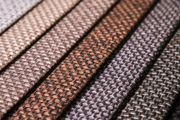 Colorful and bright fabric samples of furniture and clothing upholstery. Close-up of a palette of...