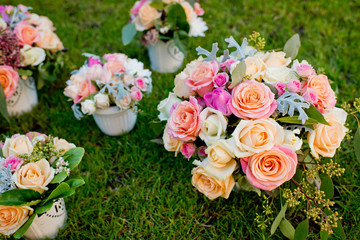 Five different wedding bouquets on a green grass. Close-up.