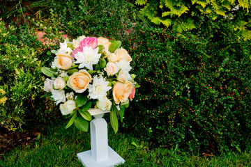 Wedding bouquet on a green grass in the park.