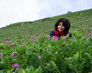 Woman smelling purple flowers