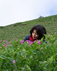 Woman smelling purple flowers