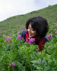 Woman smelling purple flowers