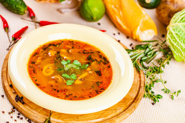 Vegetable soup with herbs and spices in white plate