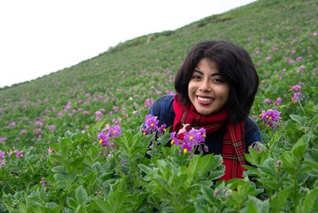 Woman smelling purple flowers