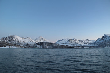 Snow-covered mountains in Norway fjord