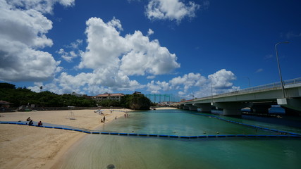 Dedicated area for beach relaxation and swimming in a sea under the bridge in Haha, Okinawa, Japan.