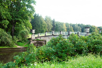 old vintage bridge on river in green park, landscape historical