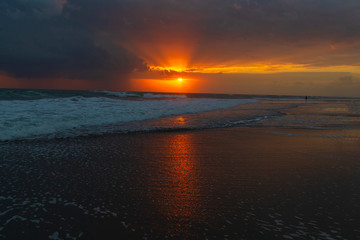 Fototapeta premium Beautiful colorful sunset at the sea with dramatic clouds and sun shining.Colorful dawn over the sea. Nature composition.
