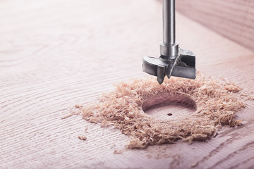 metal drill bit forstner make holes in a wooden oaks plank